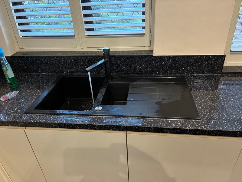 Black granite double sink with mosaic pattern countertop