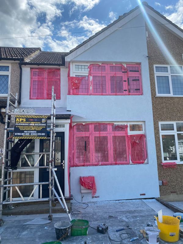 House renovation with scaffolding and APS branding