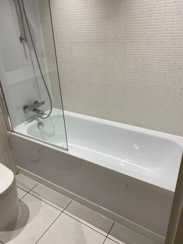 White bathroom with glass shower enclosure